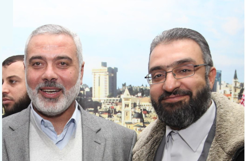  Amin Abu Rashid (right) with Hamas leader Ismail Haniyeh  (photo credit: FACEBOOK)