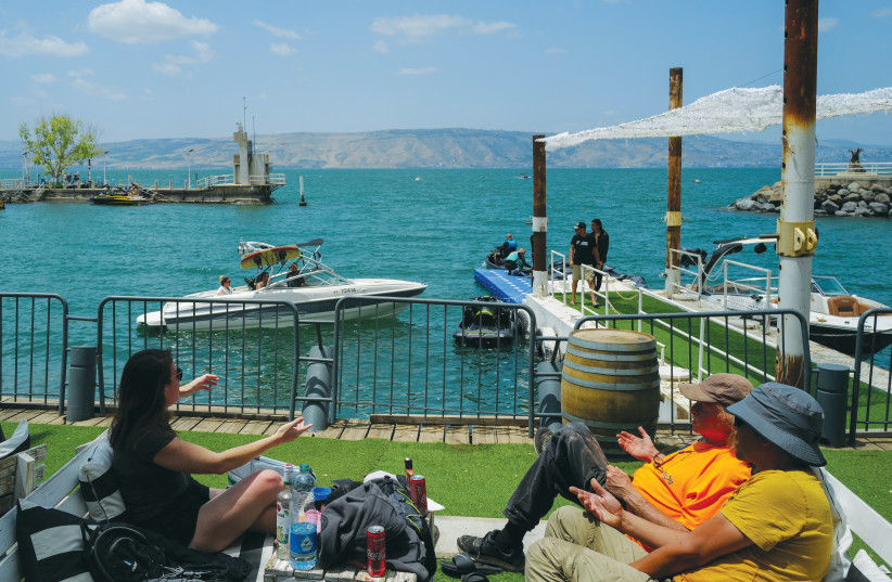  RESTING AND water sports at Ein Gev on the shores of the Kinneret: If your knowledge of Israel came from the media, you’d assume Israel has been a war zone for all its 75 years, says the writer. (photo credit: MICHAEL GILADI/FLASH90)