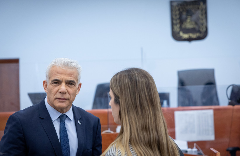 Opposition leader and former prime minister Yair Lapid arrives to testify in the trial against Israeli prime minister Benjamin Netanyahu at the District Court in Jerusalem on June 13, 2023.  (photo credit: YONATAN SINDEL/FLASH90)