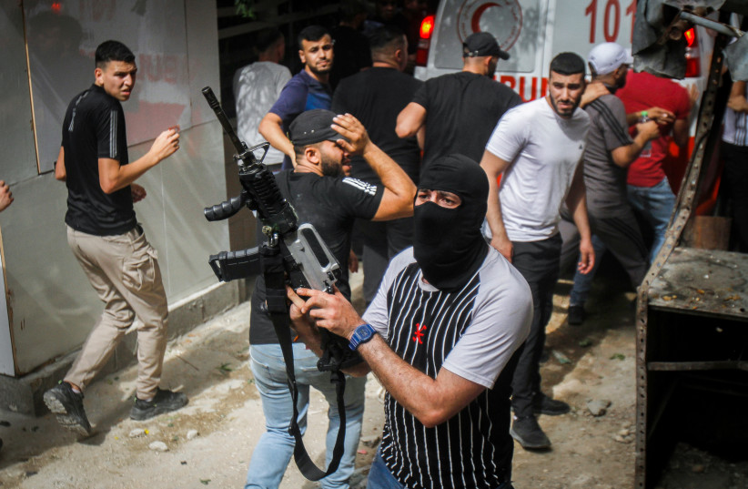  An armed Palestinian man seen at the Balata refugees camp during a raid of the Israeli army, on June 13, 2023 (photo credit: NASSER ISHTAYEH/FLASH90)