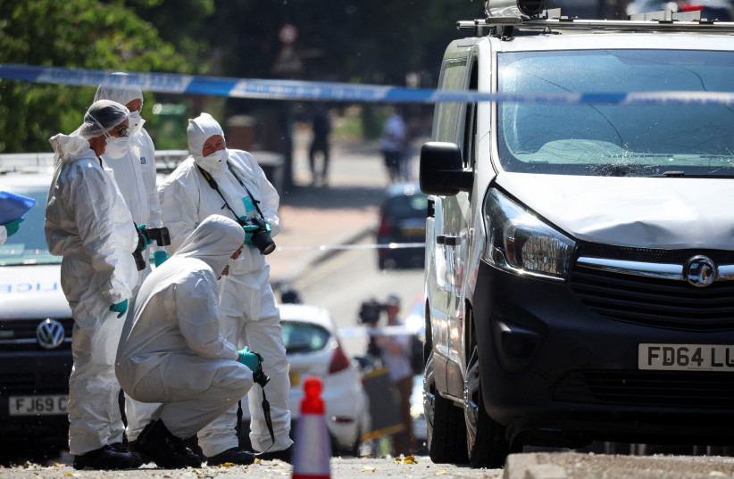  Police forensic officers work near a van in a cordon on the Bentinck Road following a deadly attack in Nottingham city centre, Nottingham, Britain, June 13, 2023 (photo credit: REUTERS/PHIL NOBLE)
