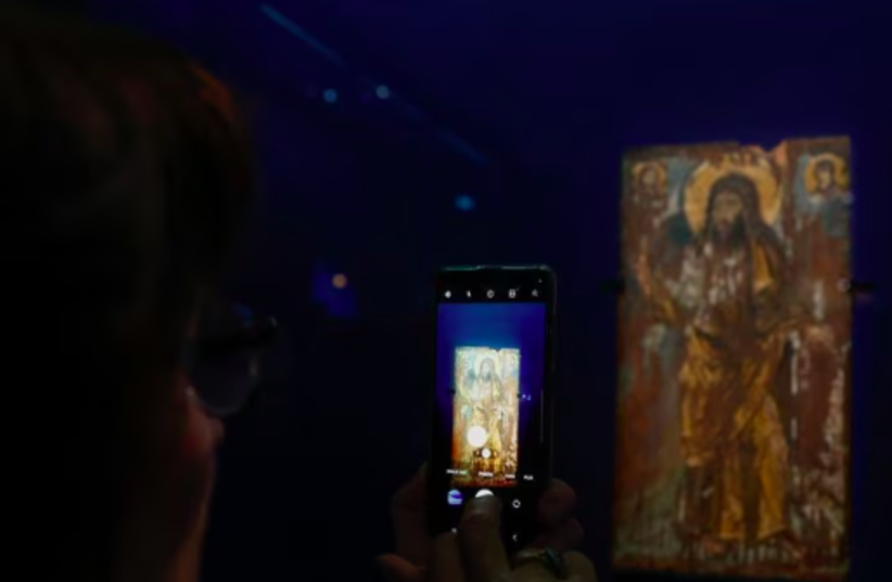 A journalist takes a picture of Saint John the Baptist 6th century Encaustic painting on wood panel, a rare Byzantine icon from the collections of the Bohdan and Varvara Khanenko Museum in Kyiv (photo credit: REUTERS)