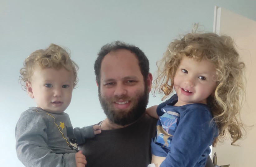  MEIR TAMARI enjoys the company of his one-year-old child Yahav and two-and-a-half-year-old Alma, at their home in Hermesh, in April, about a month before he was murdered.  (photo credit: TAL TAMARI)