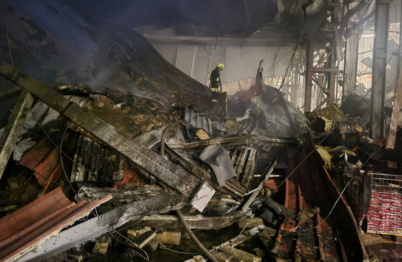  A firefighter works at a site of a food warehouse heavily damaged by a Russian missile strike, amid Russia's attack on Ukraine, in Odesa, Ukraine June 14, 2023.  (photo credit: Press Service of the Operational Command South of the Ukrainian Armed Forces/Handout via REUTERS)