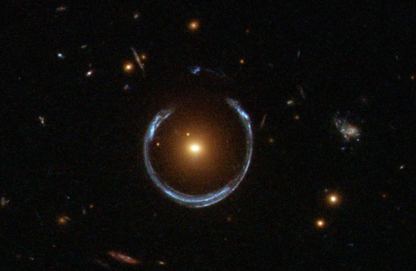  A galaxy is seen distorted into an Einstein ring due to gravitational lensing warping space and time. (photo credit: Wikimedia Commons)
