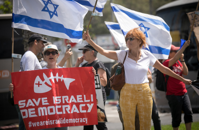  Demonstrators protest outside the AJC Global Forum where Israeli minister of Diaspora Affairs Amichai Chikli spoke, in Tel Aviv, on June 14, 2023.  (photo credit: MIRIAM ALSTER/FLASH90)