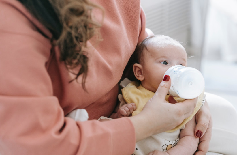  Illustrative image of a baby drinking from a bottle. (photo credit: PEXELS)