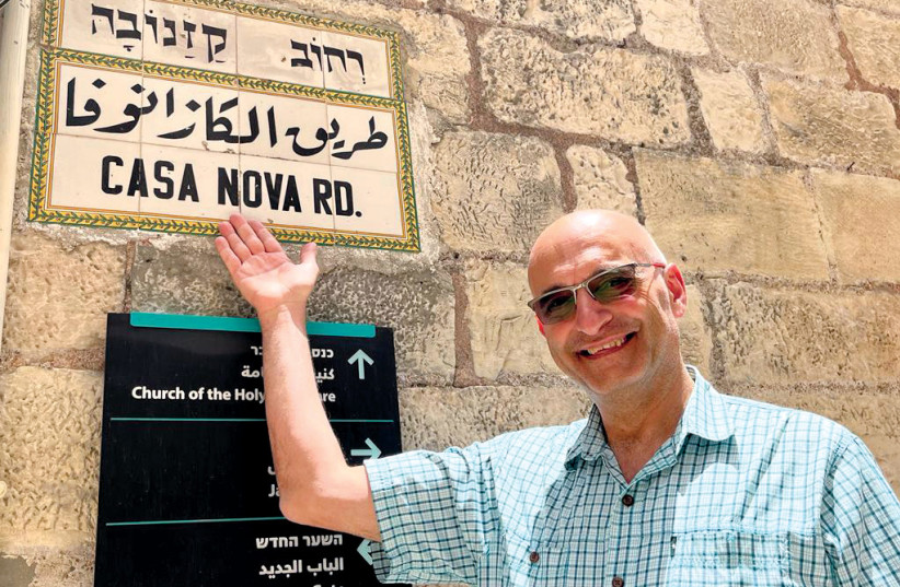  Hagop Karakashian points to the Old City street sign his father painted for Jordan, and then later for Israel in 1967. (photo credit: NICOLE SCHIAVI)