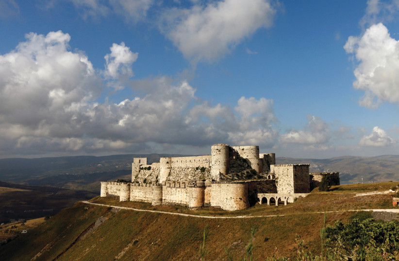  THE CRUSADER castle of Crac des Chevaliers in Homs province, Syria, in 2016. The novel takes place during the Crusader era.  (photo credit: OMAR SANADIKI/REUTERS)