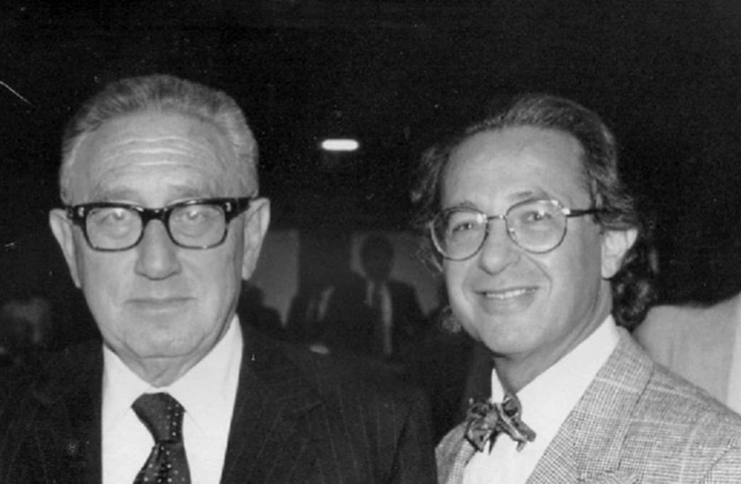  THE WRITER poses with Henry Kissinger in a photo taken in 1990. (photo credit: Courtesy Mark Elovitz)