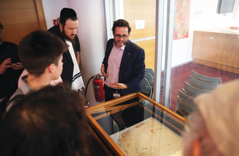  CHAIM NERIA (right), curator of the Haim and Hanna Solomon Judaica Collection at the National Library of Israel, speaks about the new collection. (photo credit: Uri Bareket/The National Library of Israel)