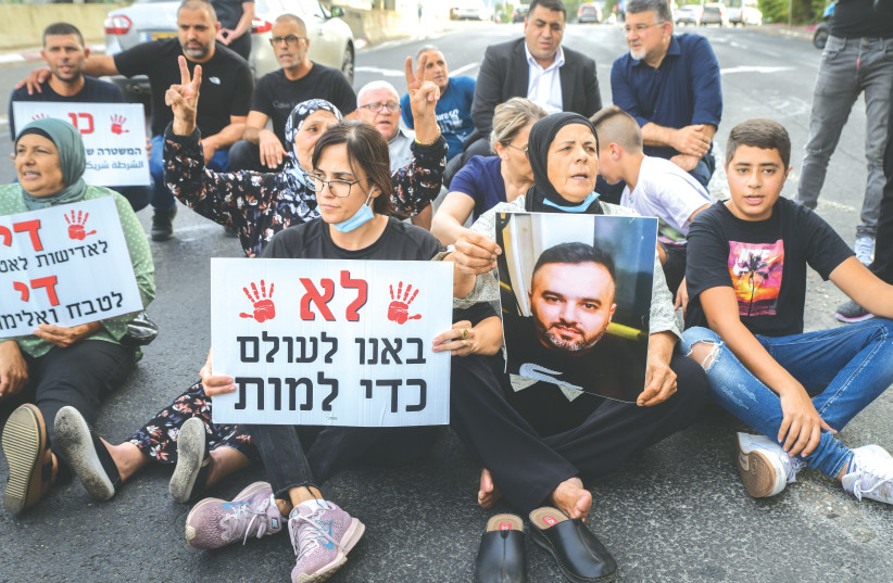  ARAB ISRAELIS block a road in Tel Aviv as they protest against violence, organized crime and murders in their communities, in October 2021.  (photo credit: AVSHALOM SASSONI/FLASH90)