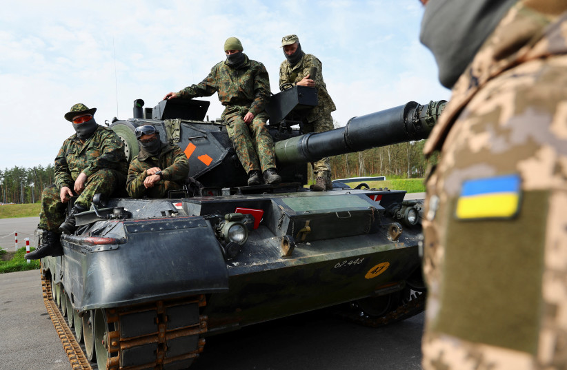 Ukrainian soldiers are pictured on a Leopard 1A5 tank, at the German army Bundeswehr base, part of the EU Military Assistance Mission in support of Ukraine (EUMAM Ukraine) in Klietz, Germany, May 5, 2023 (photo credit: REUTERS/FABRIZIO BENSCH)