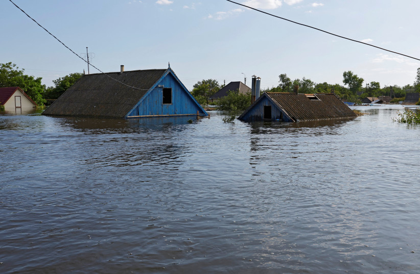 A view shows a flooded residential area following the collapse of the Nova Kakhovka dam in the course of Russia-Ukraine conflict, in the town of Hola Prystan in the Kherson region, Russian-controlled Ukraine, June 8, 2023.  (photo credit: REUTERS/ALEXANDER ERMOCHENKO)