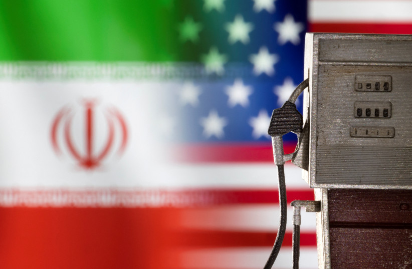  Model of petrol pump is seen in front of US and Iran flag colors in this illustration taken March 25, 2022. (photo credit: DADO RUVIC/REUTERS ILLUSTRATION)