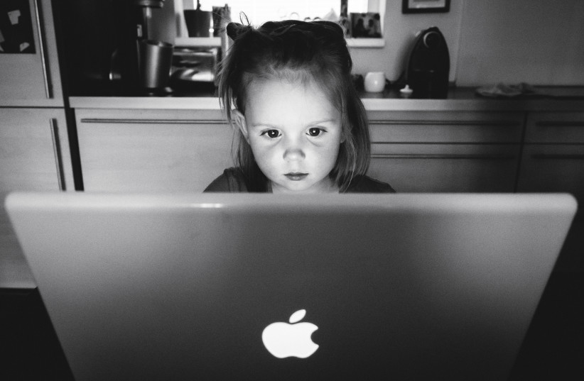  Young child uses the computer. (photo credit: Wikimedia Commons)