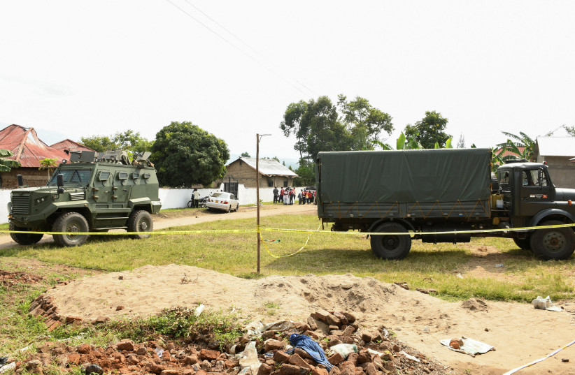  Ugandan security forces cordon the scene outside the Mpondwe Lhubirira Secondary School, after militants linked to rebel group Allied Democratic Forces (ADF) killed and abducted multiple people, in Mpondwe, western Uganda, June 17, 2023 (photo credit: REUTERS)