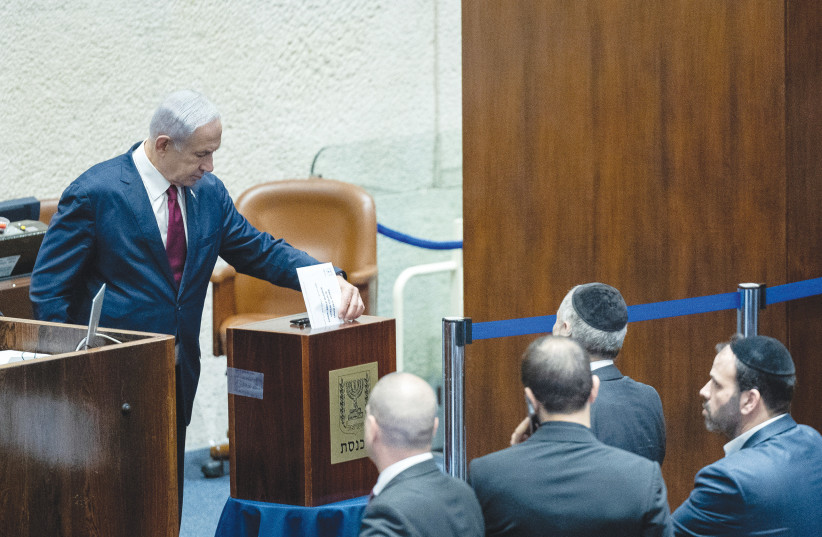  PRIME MINISTER Benjamin Netanyahu votes last Wednesday in the Knesset for an MK to serve on the Judicial Selection Committee (photo credit: YONATAN SINDEL/FLASH90)