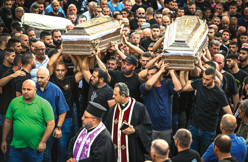  MOURNERS CARRY the coffins of people murdered in a shooting in Yafa an-Naseriyye, near Nazareth, earlier this month (photo credit: FLASH90)