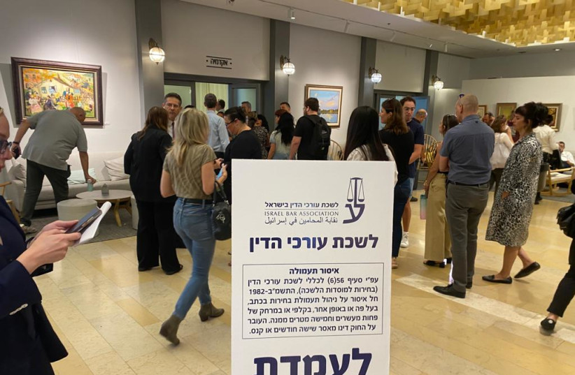  People stand in line at an election booth for the Israel Bar Association vote on June 20, 2023 (photo credit: AVSHALOM SASSONI/MAARIV)