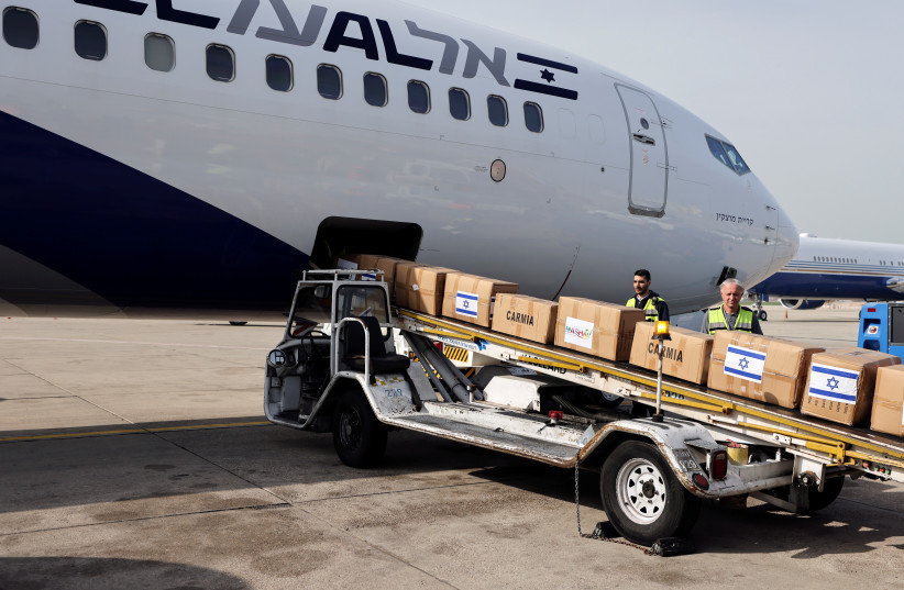  Workers handle packages of Israeli humanitarian aid destined for Ukraine, at Ben Gurion International Airport, near Tel Aviv, Israel March 1, 2022 (photo credit: REUTERS/AMMAR AWAD)