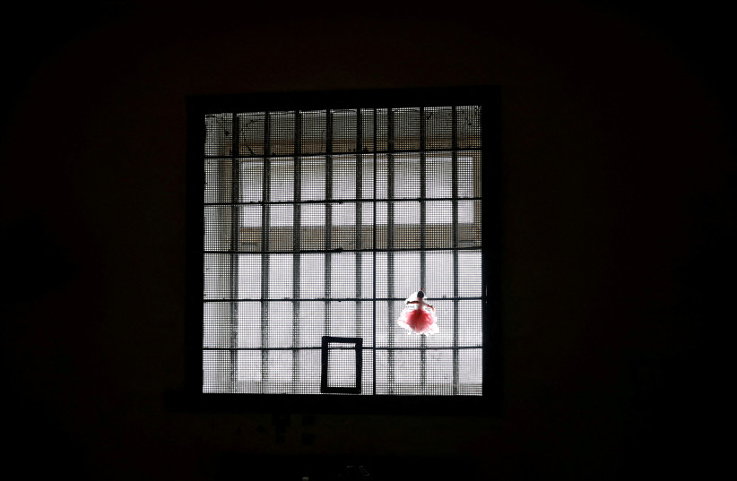  A rag doll is attached on the window of a cell at a preliminary detention centre which, as Ukrainians say, was used by Russian service members to jail and torture people before they retreated from Kherson, Ukraine November 16, 2022.  (photo credit: MURAD SEZER/REUTERS)