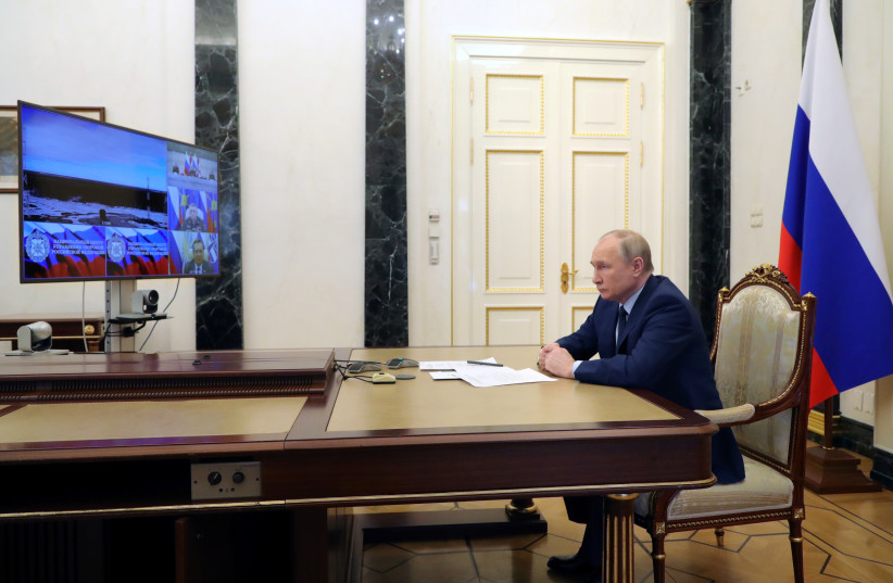  Russian President Vladimir Putin watches a test launch of the Sarmat intercontinental ballistic missile at Plesetsk cosmodrome in Arkhangelsk region, via video link in Moscow, Russia, April 20, 2022. (photo credit: SPUTNIK/MIKHAIL KLIMENTYEV/KREMLIN VIA REUTERS)