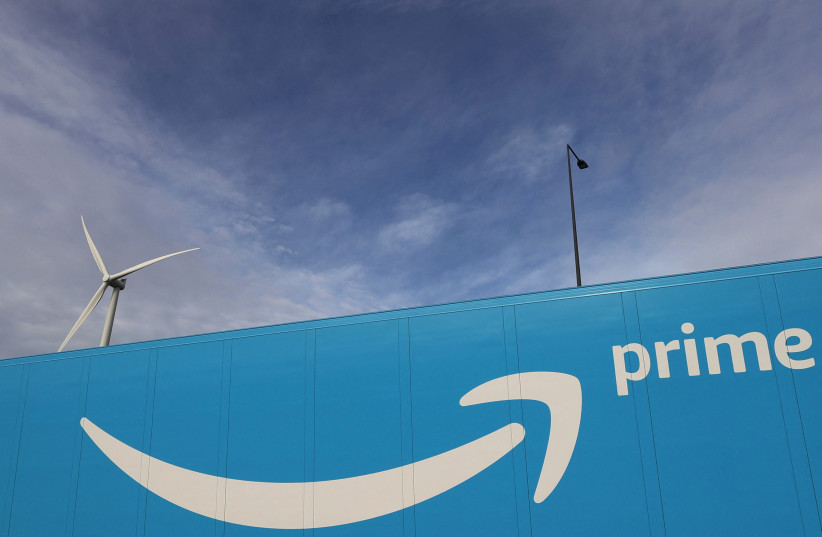 The logo of Amazon Prime Delivery is seen on the trailer of a truck outside the company logistics center in Lauwin-Planque, northern France, November 15, 2022.  (photo credit: PASCAL ROSSIGNOL/REUTERS)