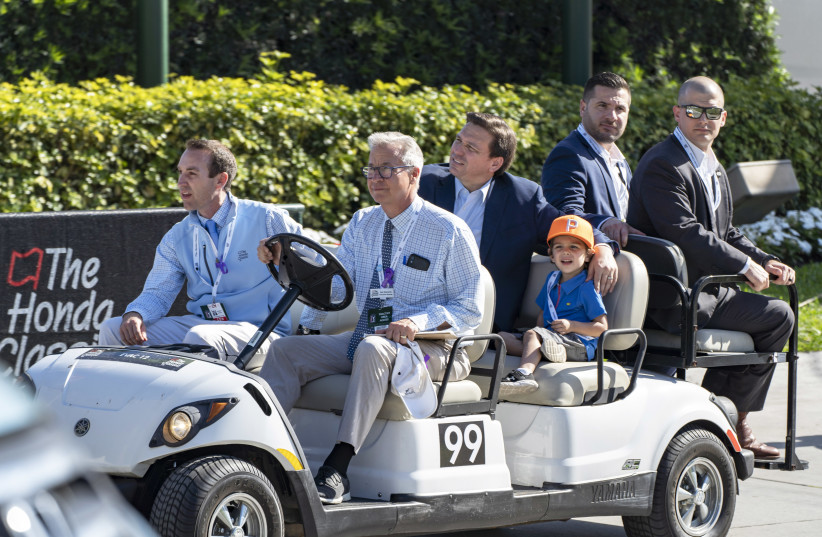  Palm Beach Gardens, Florida, USA; Andrew George, front left, and Honda Classic exectutive director Kenneth Kennerly, front, drives Florida Governor Ron DeSantis and his son Mason and security during the second round of the Honda Classic at PGA National Resort And Spa on February 25, 2022 (photo credit: Greg Lovett-USA TODAY NETWORK)