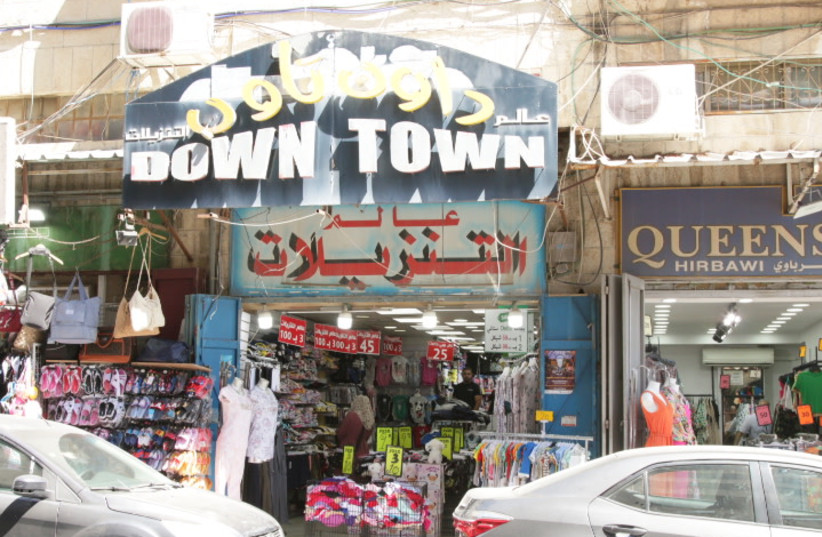  A number of stores are seen in downtown eastern Jerusalem in this illustrative image. (photo credit: SHMUEL BAR-AM)