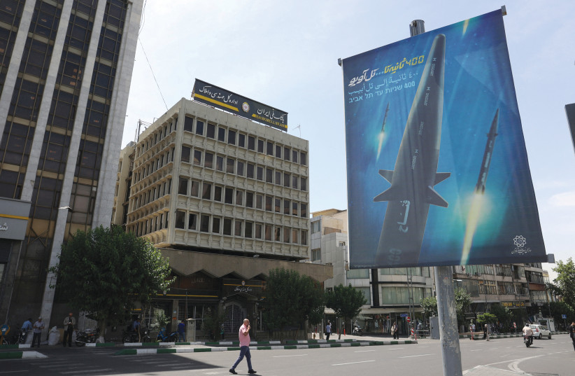  HYPING IRAN’S new hypersonic ballistic missile ‘Fattah,’ with text reading ‘400 seconds to Tel Aviv,’ seen on a street in Tehran, June 8.  (photo credit: Majid Asgaripour/WANA via Reuters)