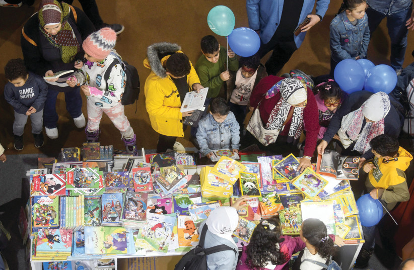  CHILDREN BROWSE books at the Cairo International Book Fair, with the participation of about 51 countries in the 54th edition of this fair, in Egypt, Jan. 31.  (photo credit: MOHAMED ABD EL GHANY/REUTERS)