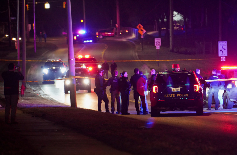  Police officers surround a scene where the suspect was located as they respond to a shooting at Michigan State University in East Lansing, Michigan, US, February 14, 2023 (photo credit: REUTERS/DIEU-NALIO CHERY)