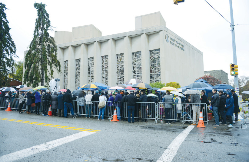  A CROWD attends a vigil outside the Tree of Life synagogue, marking one week after the deadly shooting there, in Pittsburgh, in 2018.  (photo credit: ALAN FREED/REUTERS)