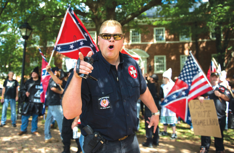  A MEMBER of the KKK shouts at counterprotesters during a rally in Charlottesville, Virginia, in 2017. The distribution of antisemitic flyers by white supremacist groups is a phenomenon that has become mainstream, according to activist Yoni Michanie.  (photo credit: Andrew Caballero-Reynolds/AFP via Getty Images)