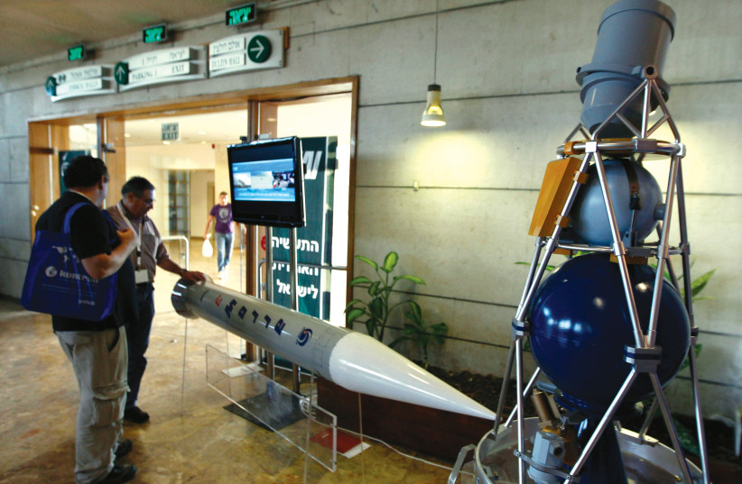  VISITORS VIEW a model of the Arrow 3 interceptor missile on display at an aerospace conference in Jerusalem.  (photo credit: BAZ RATNER/REUTERS)