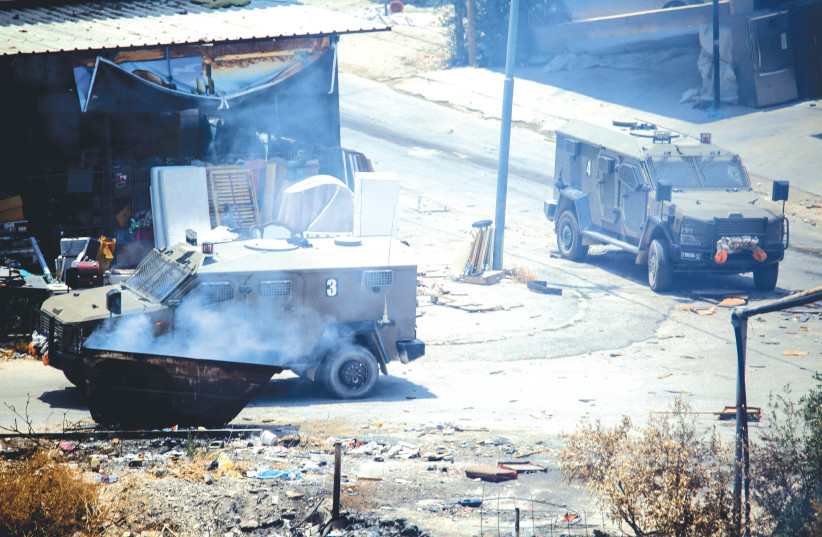  IDF VEHICLES drive through Jenin during clashes on Monday.  (photo credit: NASSER ISHTAYEH/FLASH90)
