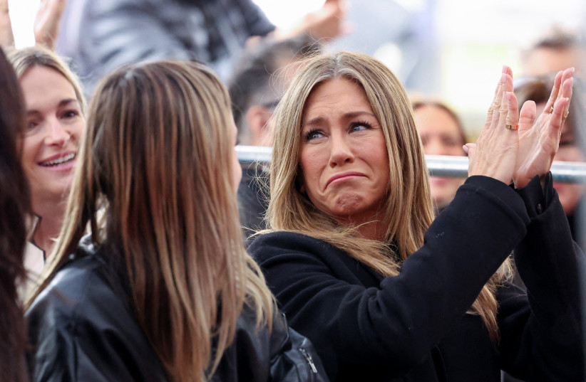  Actor Jennifer Aniston claps during actor Courteney Cox's star unveiling ceremony on the Hollywood Walk of Fame in Los Angeles California, US, February 27, 2023. (photo credit: MARIO ANZUONI/REUTERS)