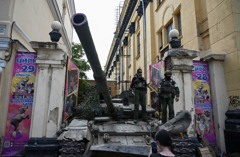 Fighters of Wagner private mercenary group stand on a tank outside a local circus near the headquarters of the Southern Military District in the city of Rostov-on-Don, Russia, June 24, 2023 (photo credit:  REUTERS/Stringer)