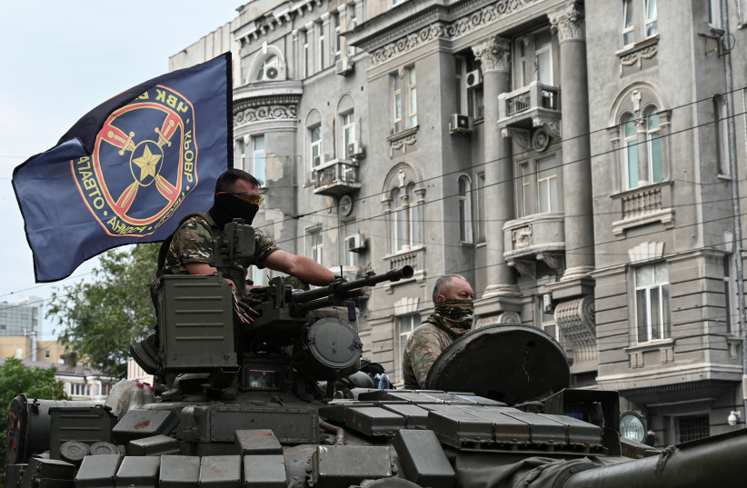 Fighters of Wagner private mercenary group stand on a tank outside a local circus near the headquarters of the Southern Military District in the city of Rostov-on-Don, Russia, June 24, 2023 (photo credit: REUTERS/STRINGER)