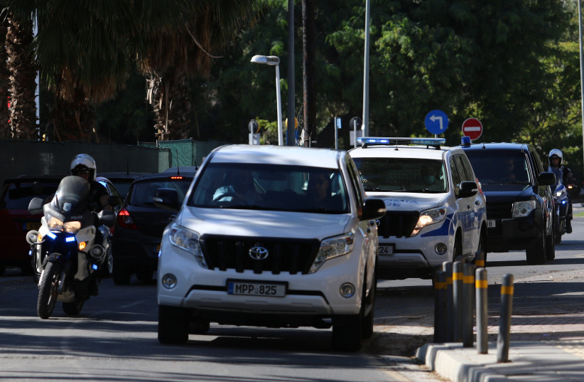  Police vehicles arrive at a court, where a remand order was issued against a man suspected of plotting to murder Israeli businesspeople on the island, in Nicosia, Cyprus October 6, 2021. (photo credit: REUTERS/YIANNIS KOURTOGLOU)