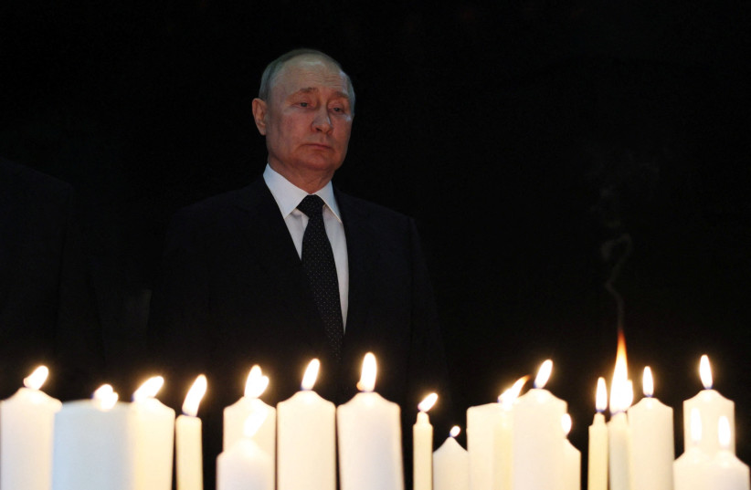  Russian President Vladimir Putin lights a candle by the Grieving Mother monument at the Victory Museum on Poklonnaya Hill on the Remembrance and Sorrow Day in Moscow, Russia June 22, 2023.  (photo credit: SPUTNIK/GAVRIIL GRIGOROV/KREMLIN VIA REUTERS)
