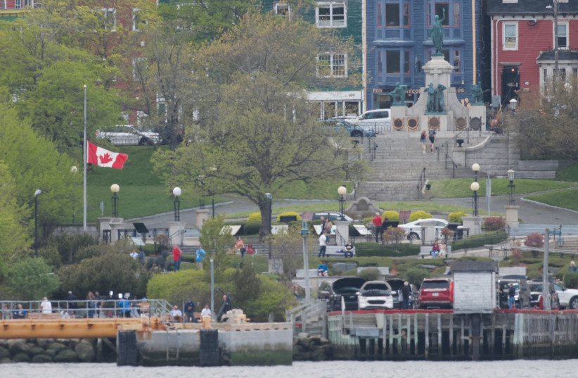  A CANADIAN FLAG flies at half mast in respect of the five victims of the loss of the Titan submersible from the OceanGate Expeditions trip to the Titanic shipwreck, in St. John’s, Newfoundland, on Friday.  (photo credit: David Hiscock/Reuters)