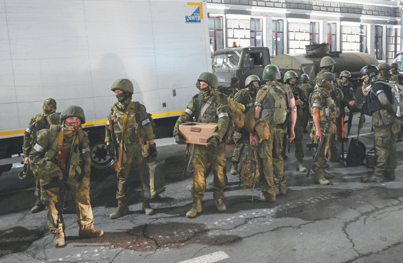  FIGHTERS OF the Wagner private mercenary group pull out of the headquarters of the southern military district, in Rostov-on-Don, Russia, on Saturday.  (photo credit: REUTERS)