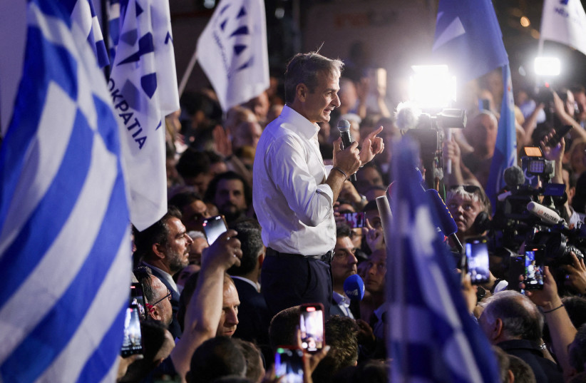  Former Greek Prime Minister and New Democracy conservative party leader Kyriakos Mitsotakis speaks to supporters outside the party's headquarters, after the general election, in Athens, Greece, June 25, 2023. (photo credit: REUTERS/LOUIZA VRADI)