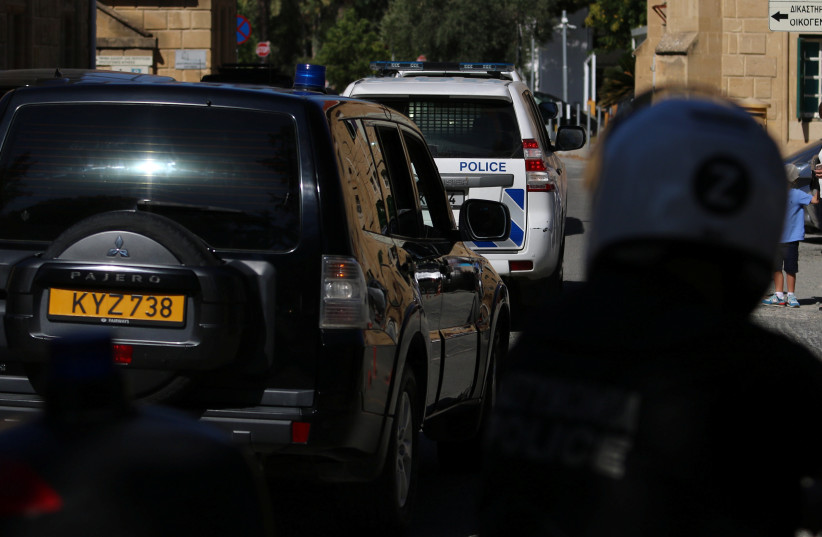  Police vehicles arrive at a court, where a remand order was issued against a man suspected of plotting to murder Israeli businesspeople on the island, in Nicosia, Cyprus October 6, 2021. (photo credit: YIANNIS KOURTOGLOU/REUTERS)