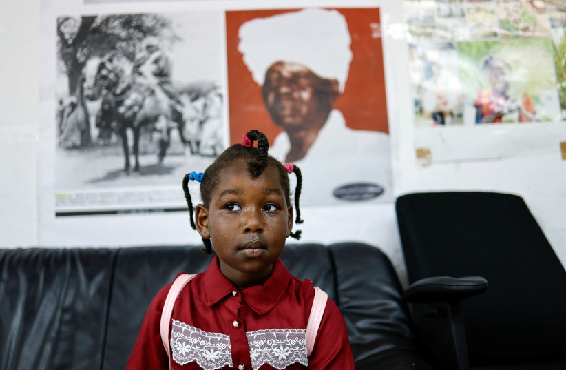 The daughter of Sudanese asylum seekers, four-year-old Ilav looks on as she sits in the Masalit tribe community centre in southern Tel Aviv, Israel June 24, 2023. (photo credit: REUTERS/AMIR COHEN)