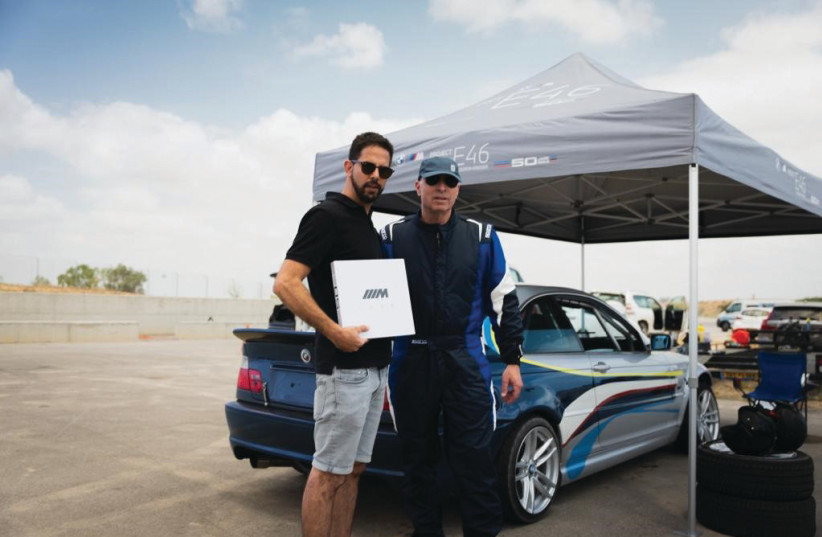  ALON GOLDMAN (left), BMW marketing manager, at Delek Motors with Dr. Doron Kreiser and his racing car. (photo credit: Tallis Clark)