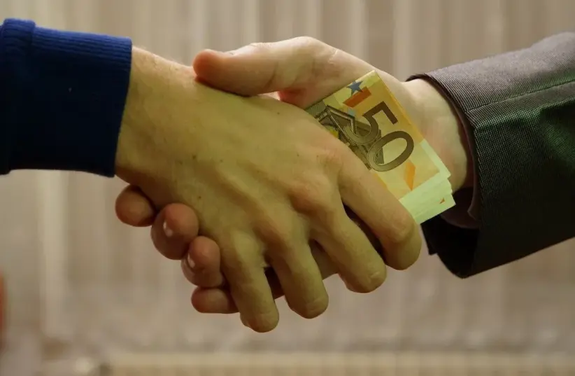  Person accepting a bribe (photo credit: CREATIVE COMMONS)