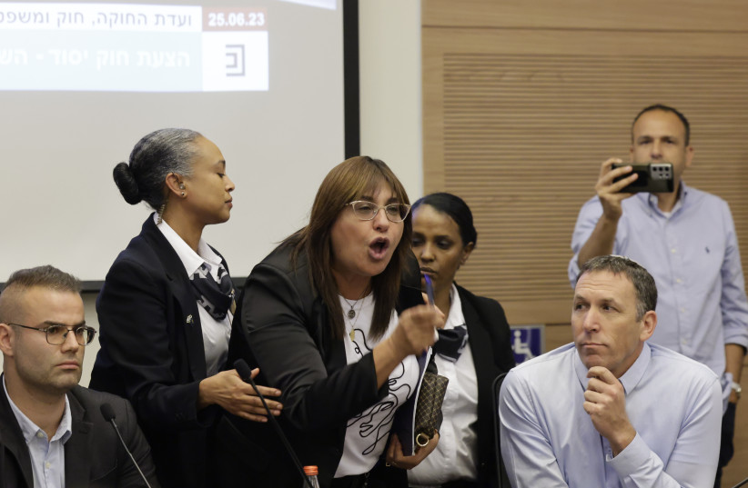  MK Dvora Biton taken out by Knesset guards during a a Constitution, Law and Justice Committee meeting on the planned judicial reform, at the Knesset, the Israeli Parliament in Jerusalem on June 25, 2023 (photo credit: MARC ISRAEL SELLEM/THE JERUSALEM POST)